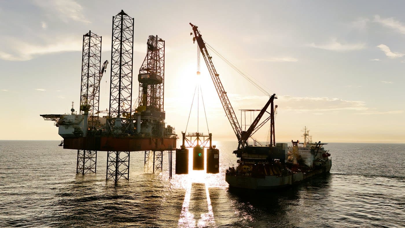 Offshore oil rig serviced by a supply vessel